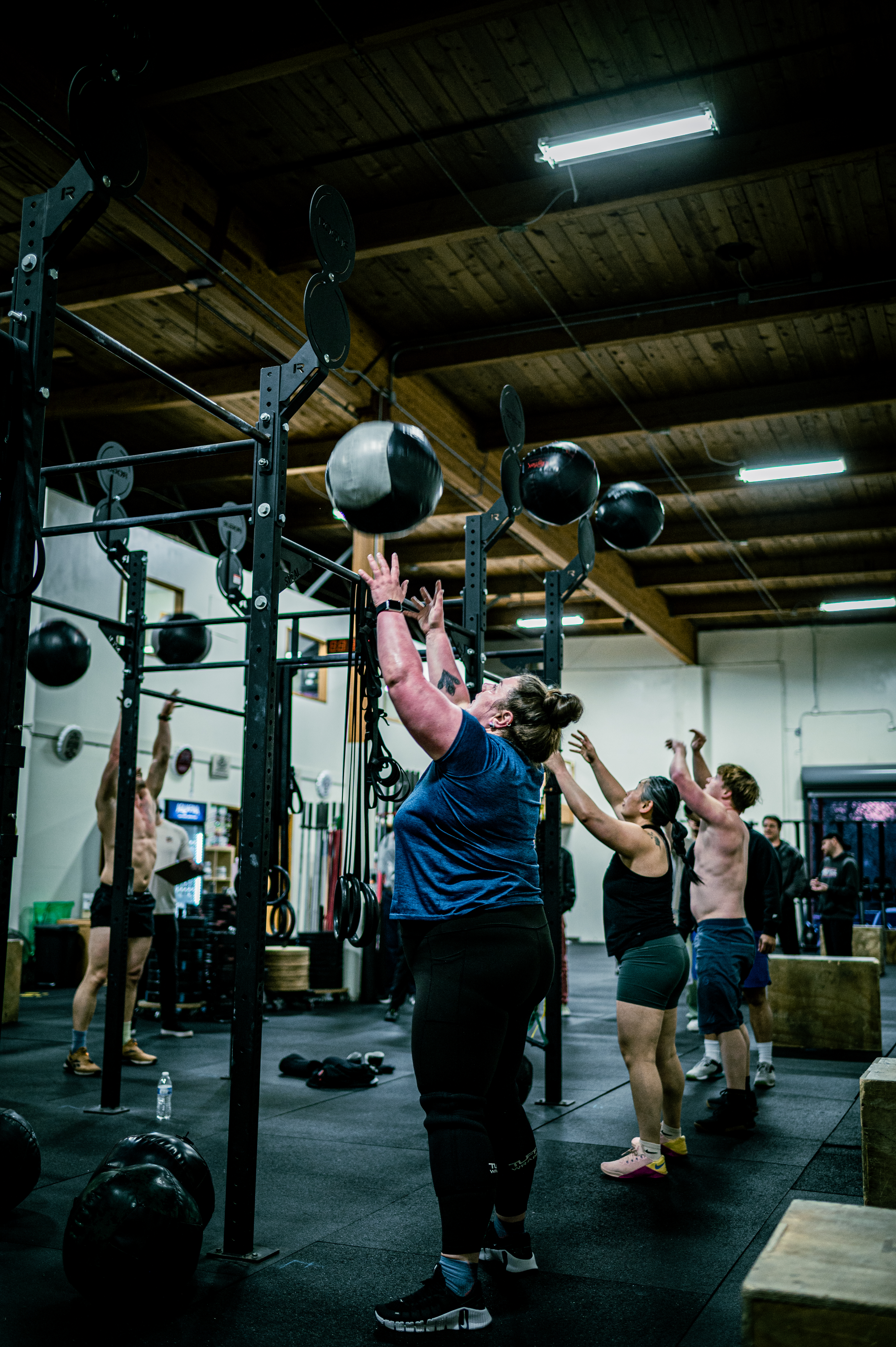 CrossFit Tigard group class throwing medicine balls together